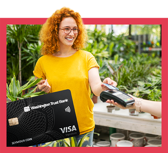 Smiling woman tapping credit card at a plant shop.