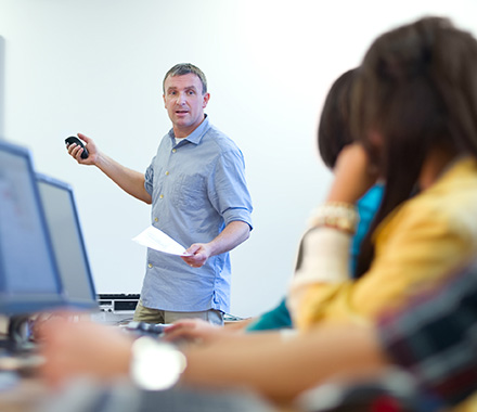 Business professional leading employee training and education on fraud prevention and security.