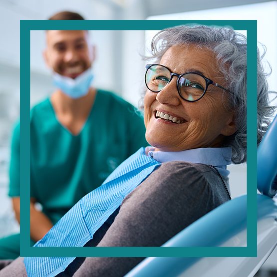 Woman wearing glasses smiling in dentist chair