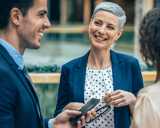 Group of professionals smiling in a conversation.