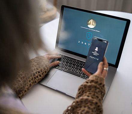 Person using multifactor authentication to help protect business networks and accounts.